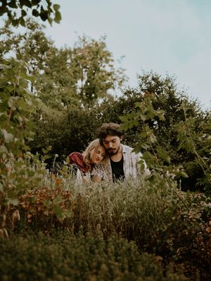 Couple sits and rests on each other for candid couples, engagement photos, elopement, and cinematic photos in Denver, Colorado