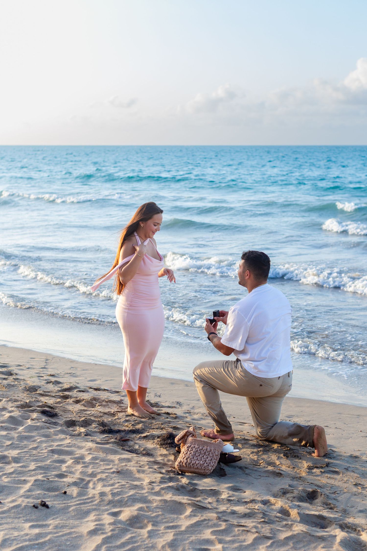 Man proposing to a woman at the beach in Isla Verde, Carolina, Puerto Rico.