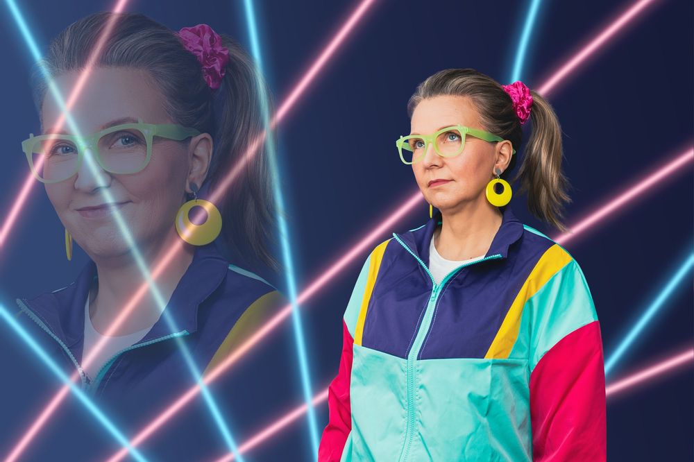 Awkward portrait of a lady wearing a bright shell suit jacket, neon accessories, staring blankly against a neon 80's laser backdrop