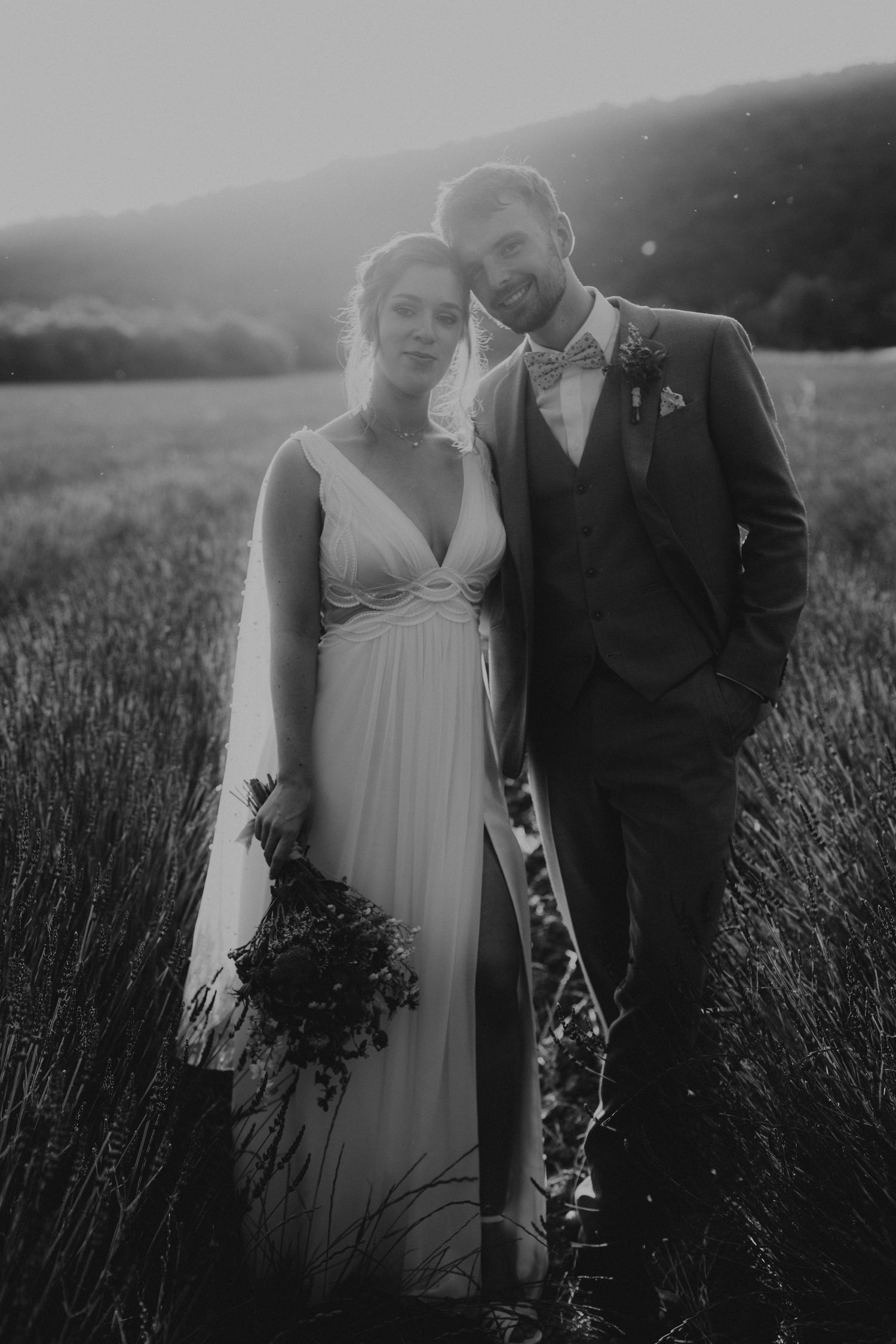 A tender autumn embrace captured during a wedding photoshoot with fall foliage.