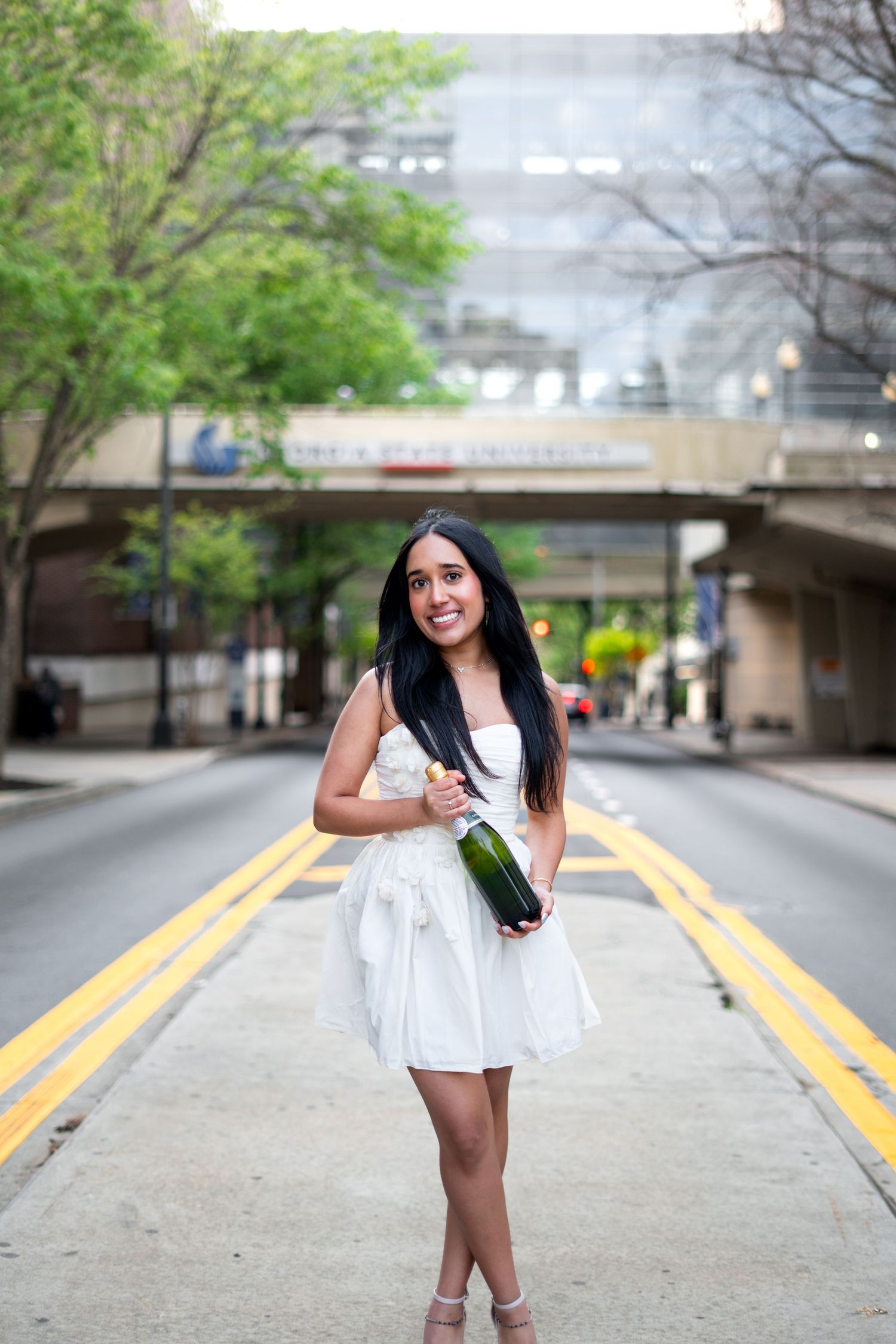 Georgia State graduation photos in front of the iconic library bridge with GSU branding, one of the best spots on the Atlanta campus