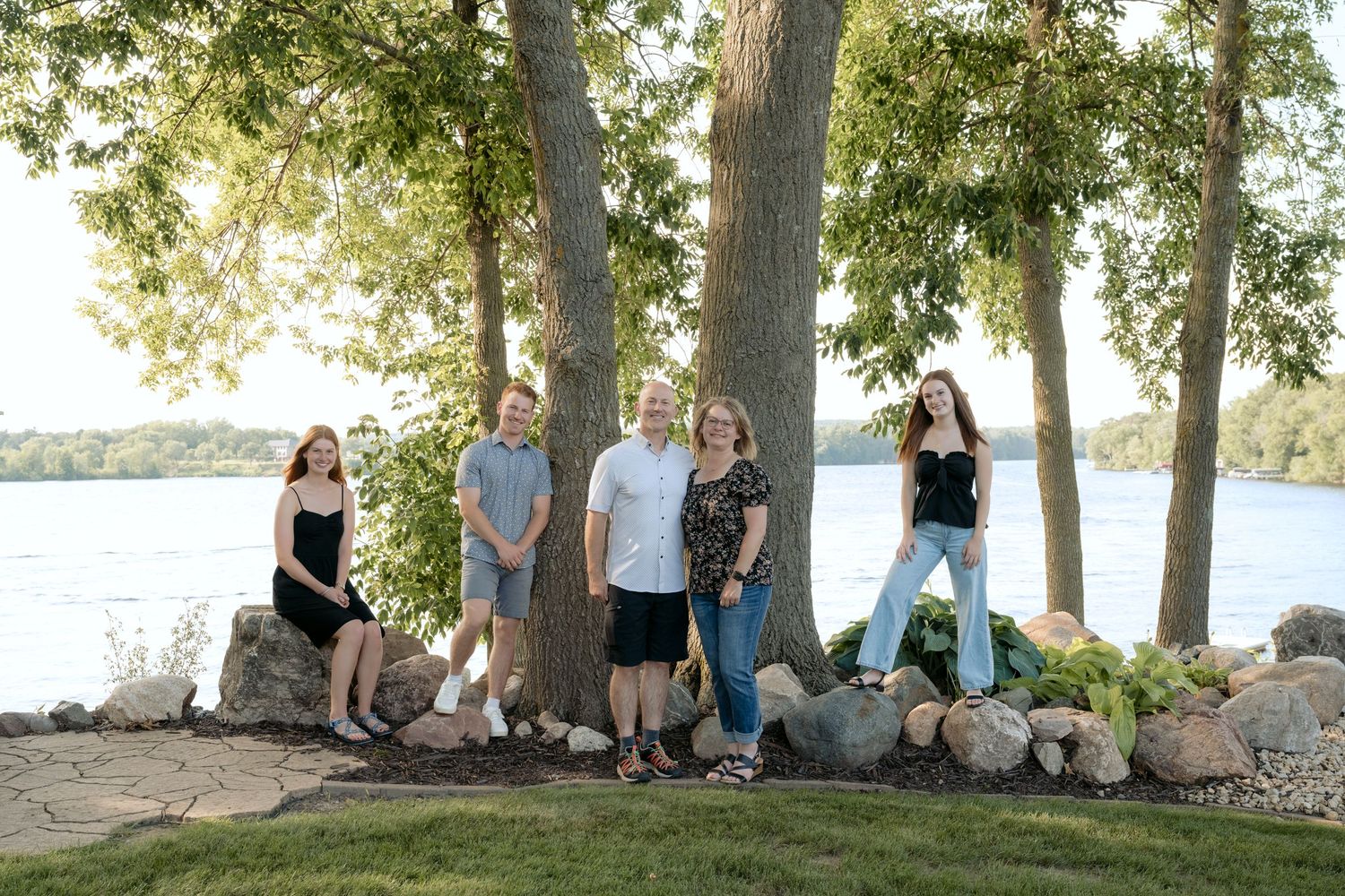 family portrait with a lake view during summer family photos at the cabin on lake wissota in chippewa falls, wi