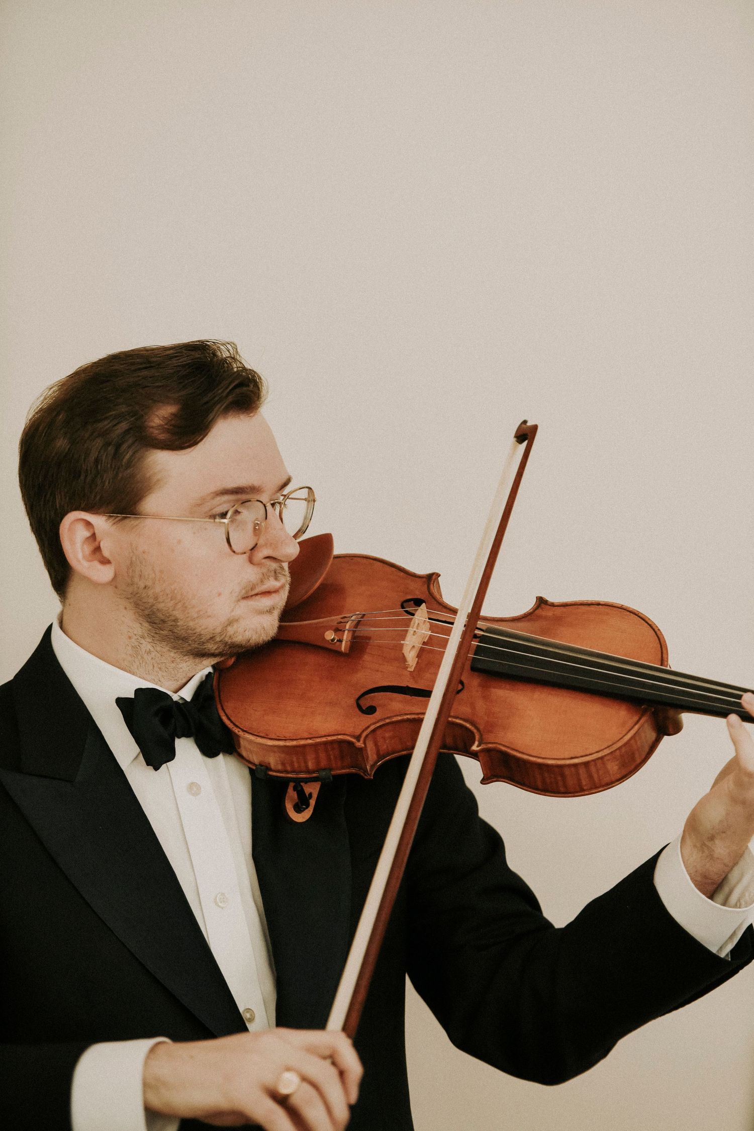 Romantic wedding ceremony in a bright modern chapel as violinist plays