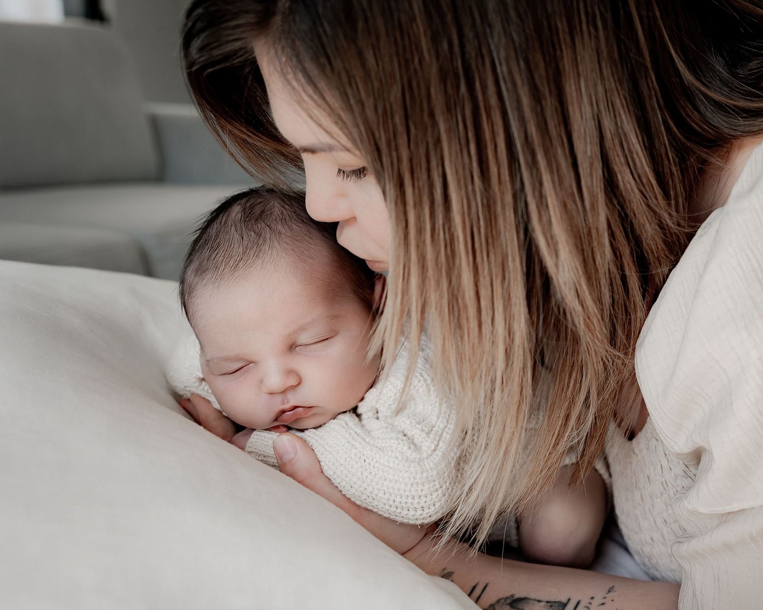 Mother holding newborn baby during portrait session