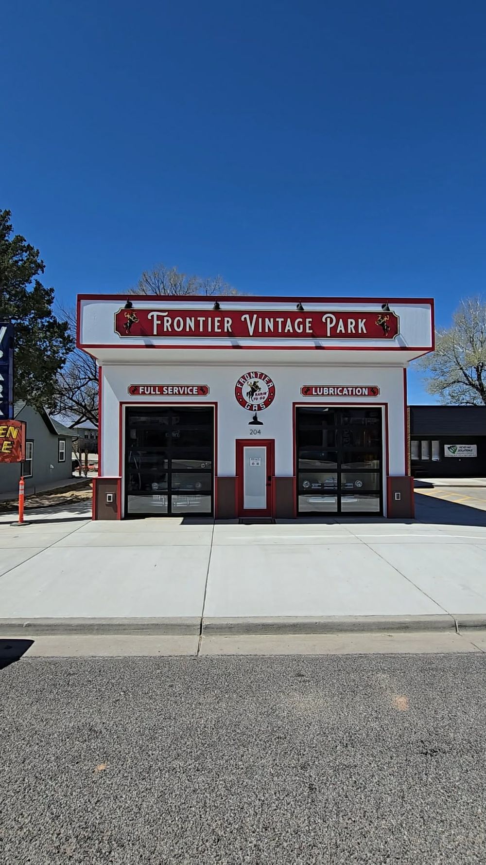 Frontier Vintage Park full-service lubrication station with classic red and white facade under a clear blue sky.