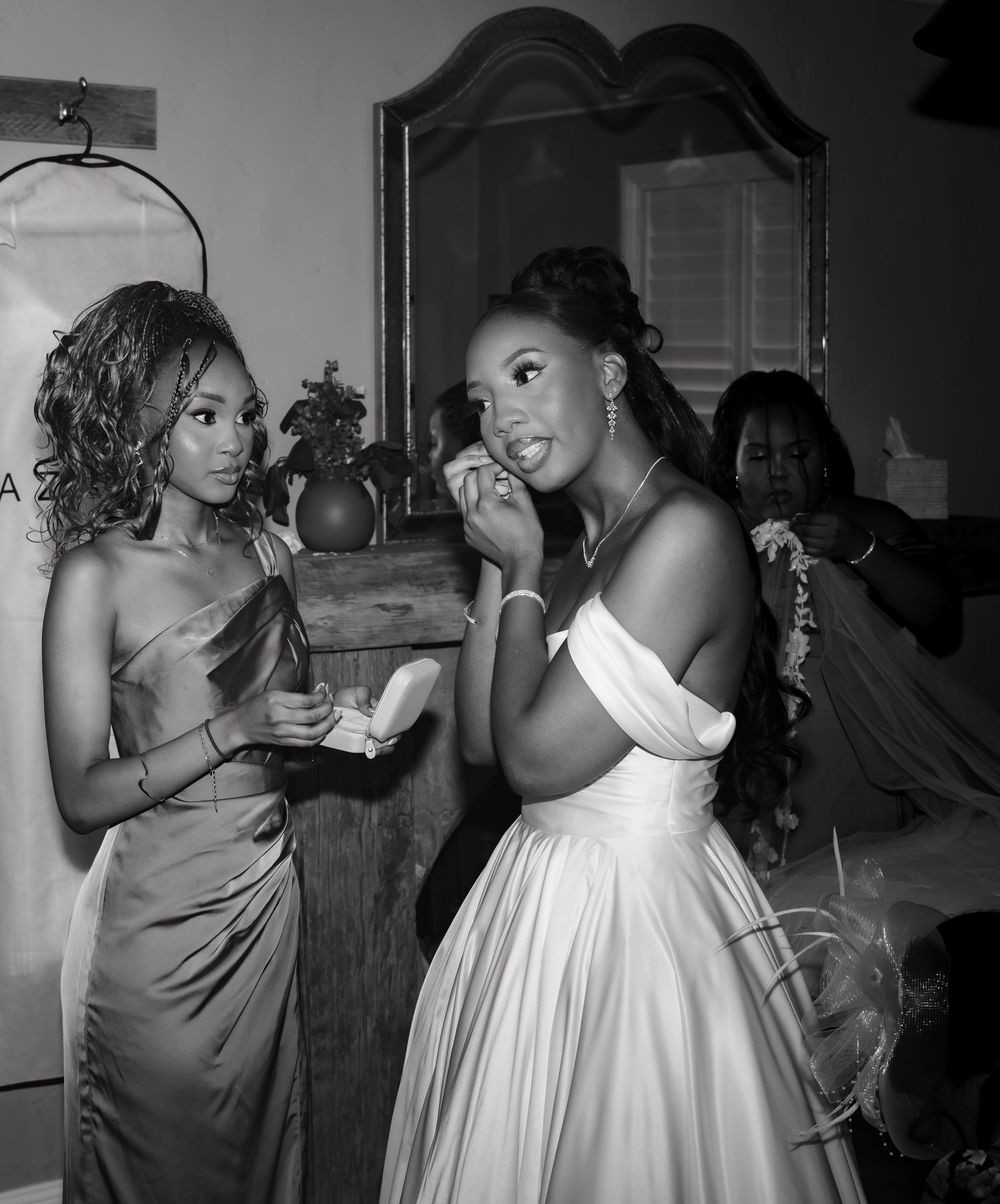 A group of people dancing and enjoying themselves at a party in black and white photography.