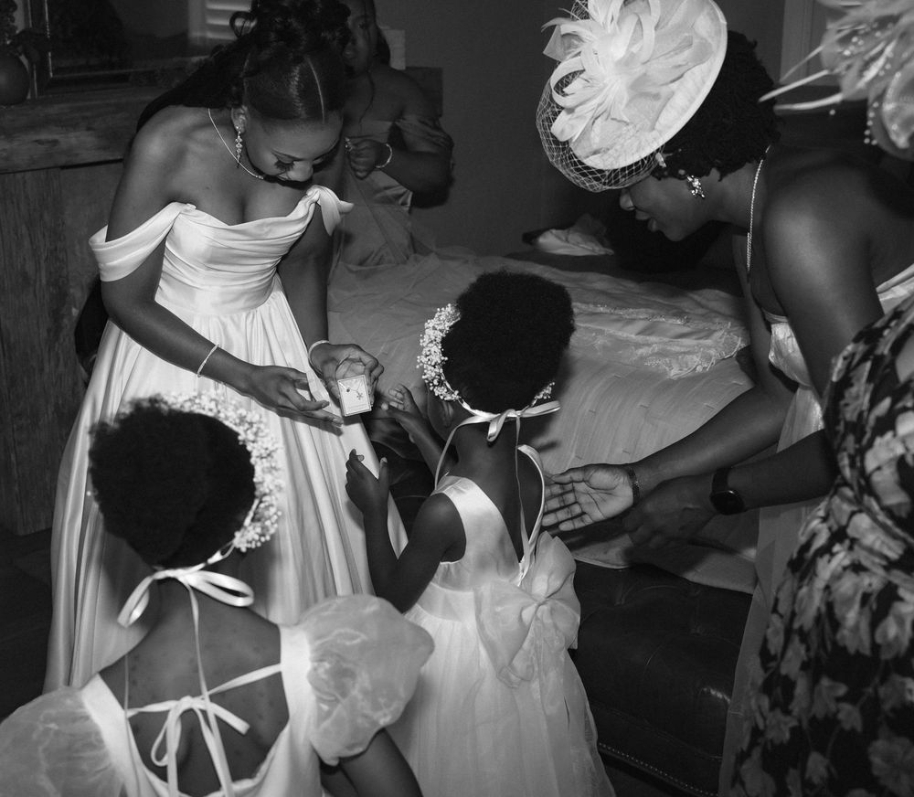 A black and white wedding photo montage showing dancing, celebrations and joyful moments at a reception.