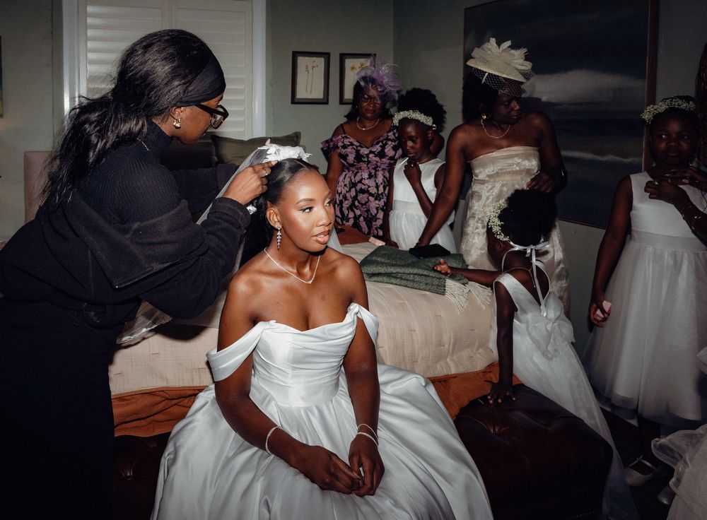 Black and white wedding photos capture dancing and celebration in a reception venue.