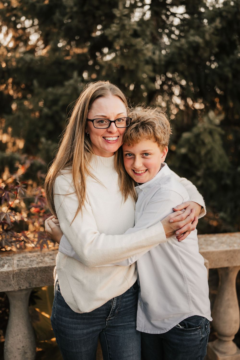 Mother hugging her child during a warm, golden-hour fall session