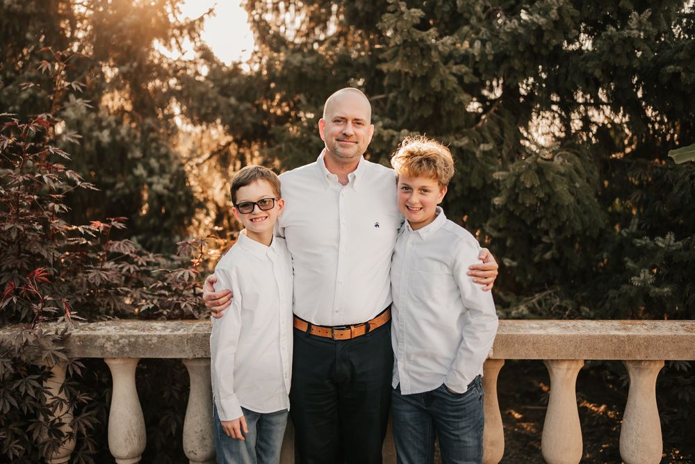 Candid moment of family laughing together during a fall photoshoot.