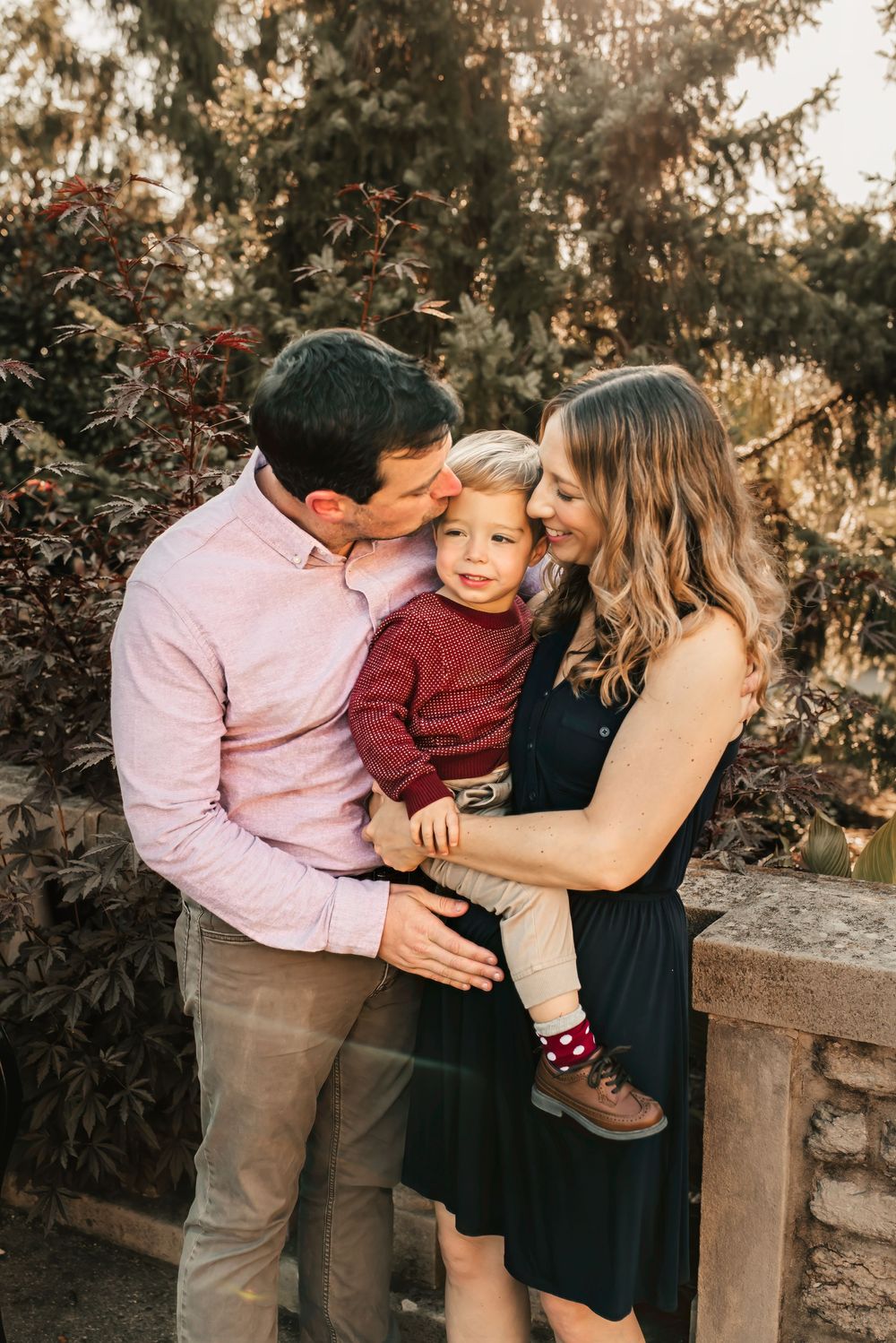 Mother hugging her child during a warm, golden-hour fall session