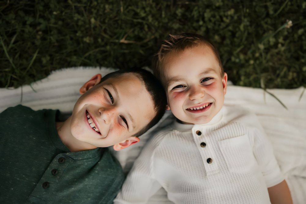 Candid moment of family laughing together during a fall photoshoot.
