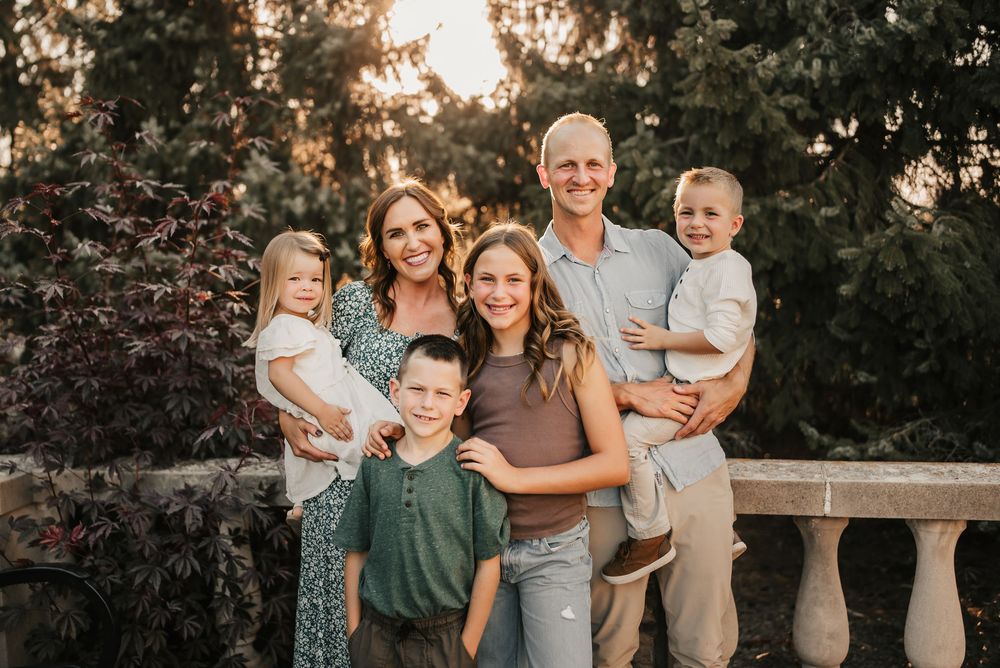 Candid moment of family laughing together during a fall photoshoot.