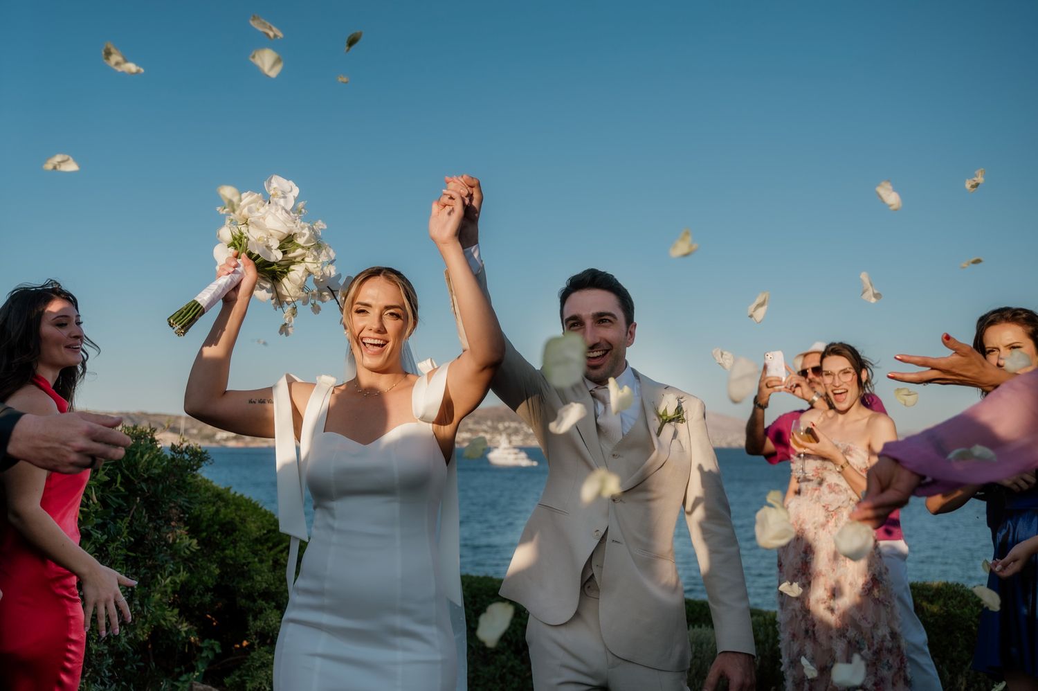 A candid photo of a couple's exit after their wedding ceremony at Island resort Athens riviera Greece