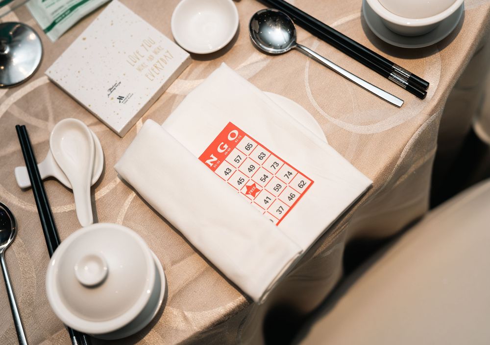 White ceramic dishes and utensils arranged on a table with a Chinese takeout menu in red print.