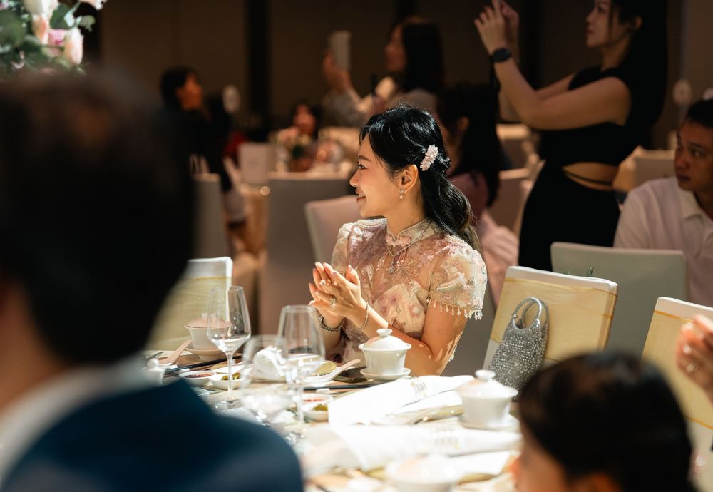 Diners seated at an elegant restaurant table with white tablecloths and wine glasses during a fine dining experience.