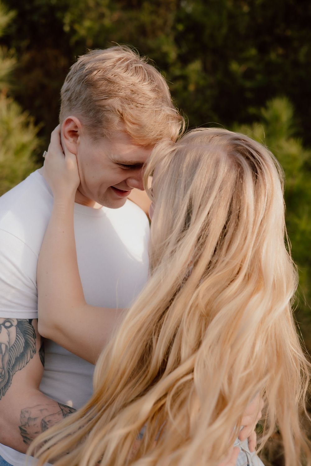Intimate couple sharing tender moments together in a romantic outdoor portrait series.