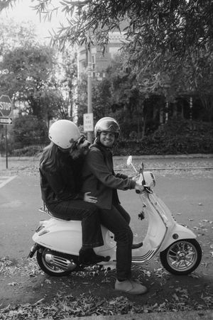Black and white photo sequence showing a person falling over while sitting on a parked scooter.