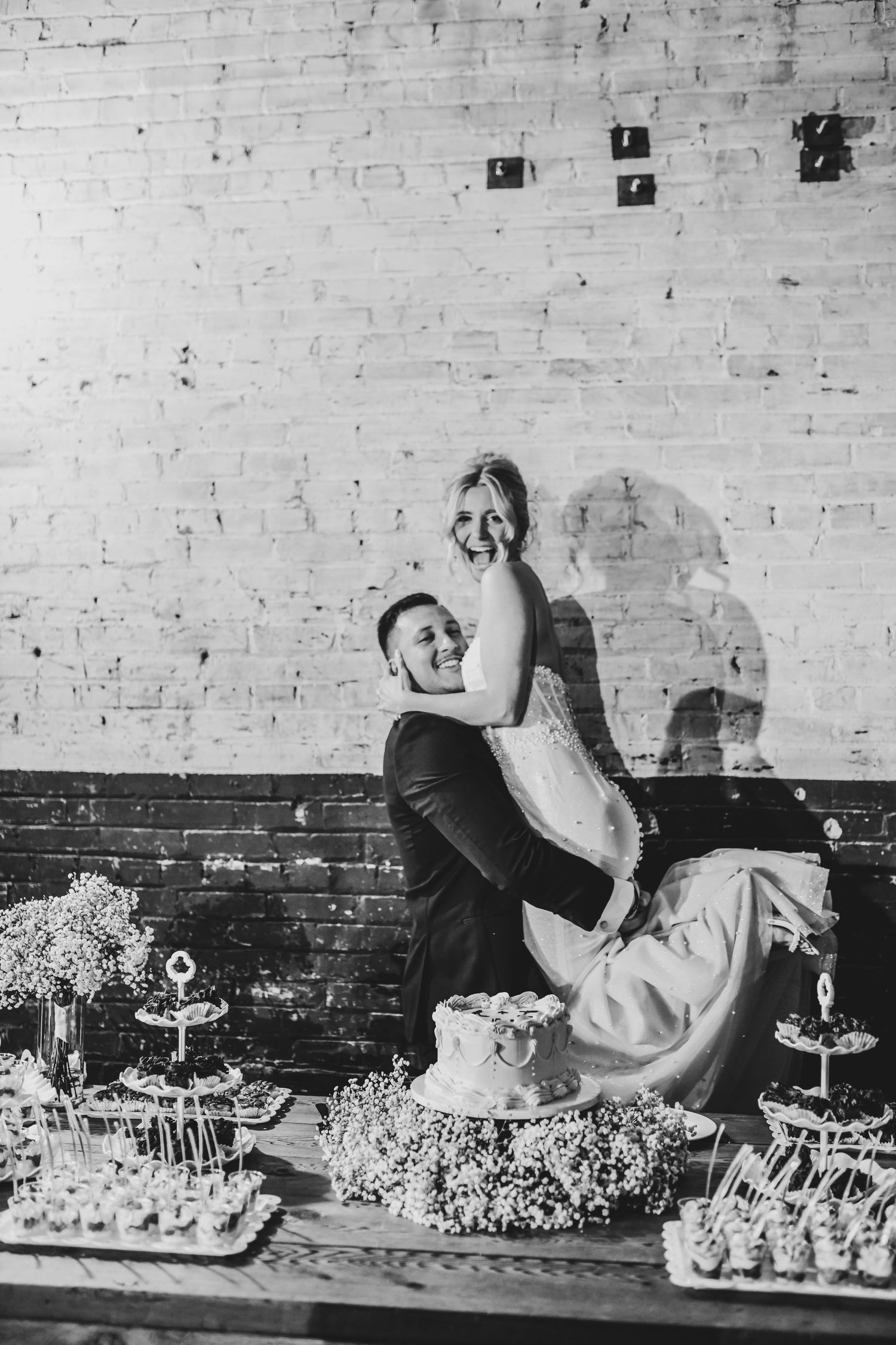 Candid cake-cutting moment with direct flash at Dallas wedding reception