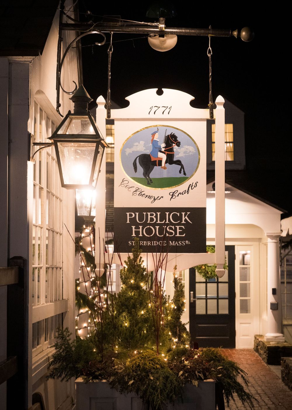 Historic Publick House exterior with illuminated signage and winter greenery decorations.