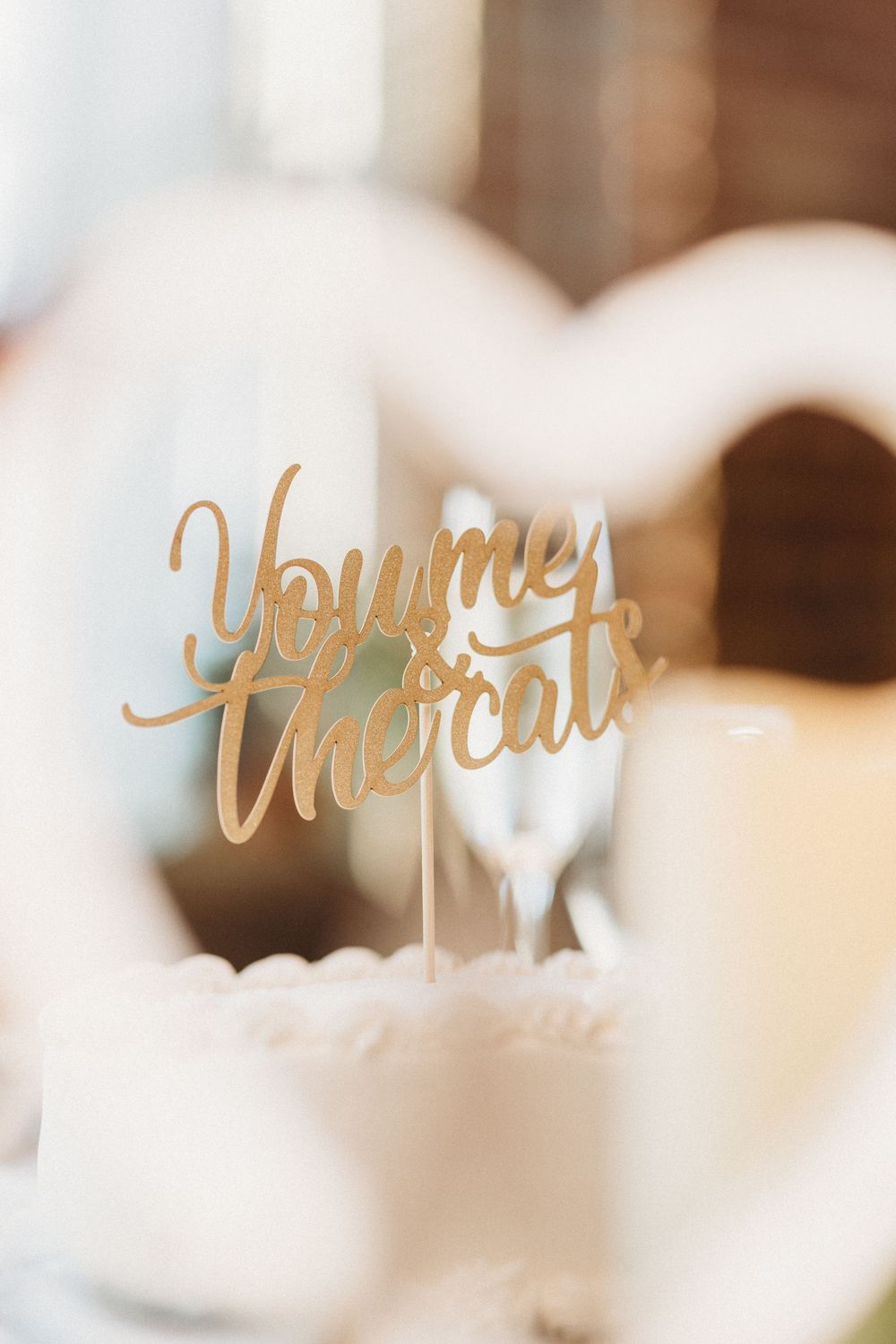 Gold script wedding table decor signs displayed in soft focus.