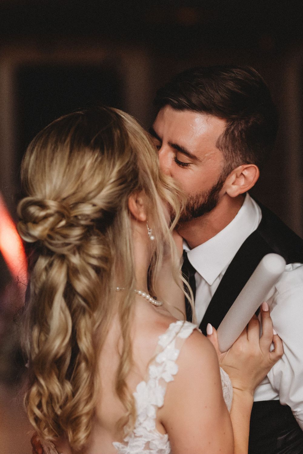 Close-up romantic moments between newlyweds during their wedding reception.