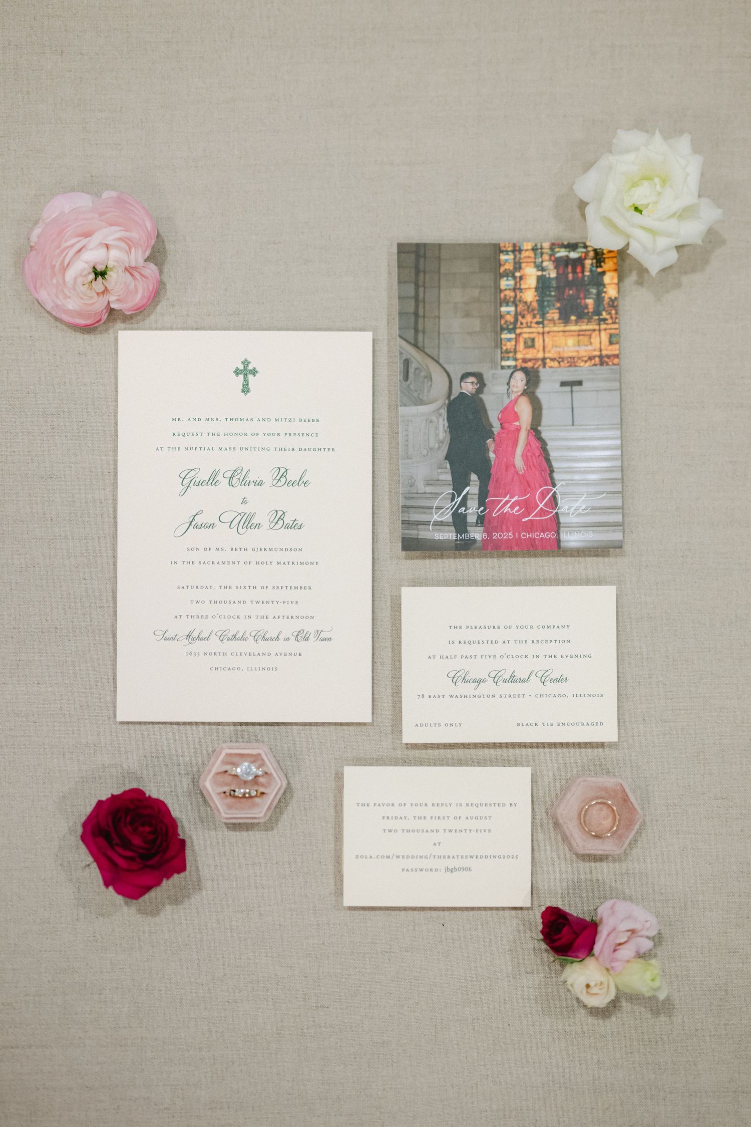 Wedding invitation suite with pink and white floral elements and elegant calligraphy displayed on neutral linen background.