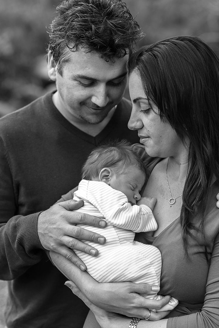 A young mother and father holding their newborn - Kelly Chapman Photographer Perth