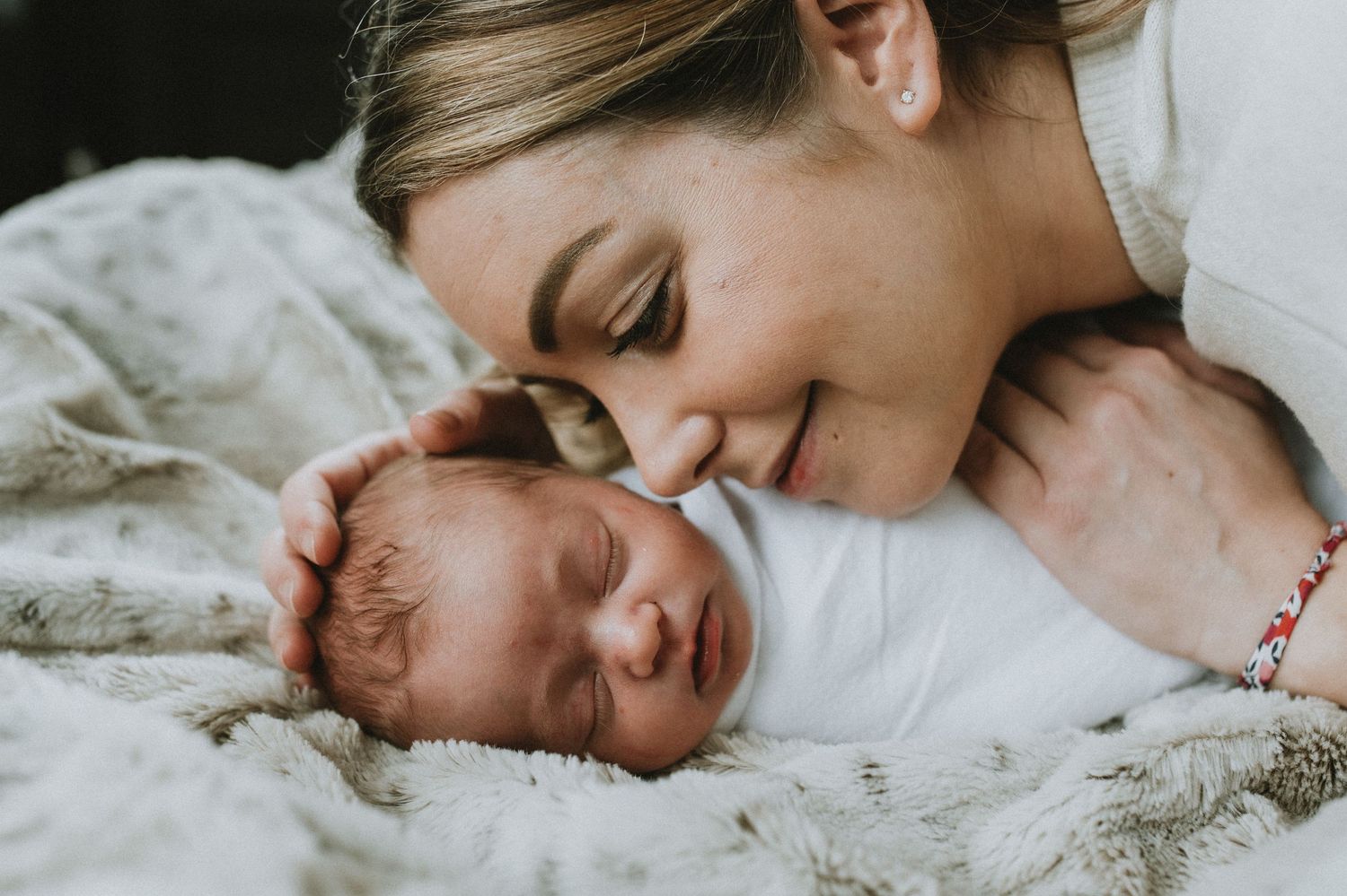 a mom giving face snuggles to their baby and smiling