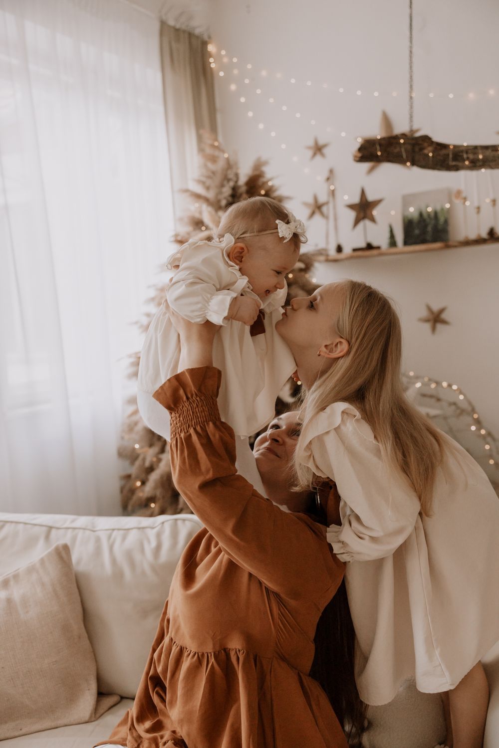 A series of candid lifestyle photos showing tender moments between parent and child in a cozy room with string lights.