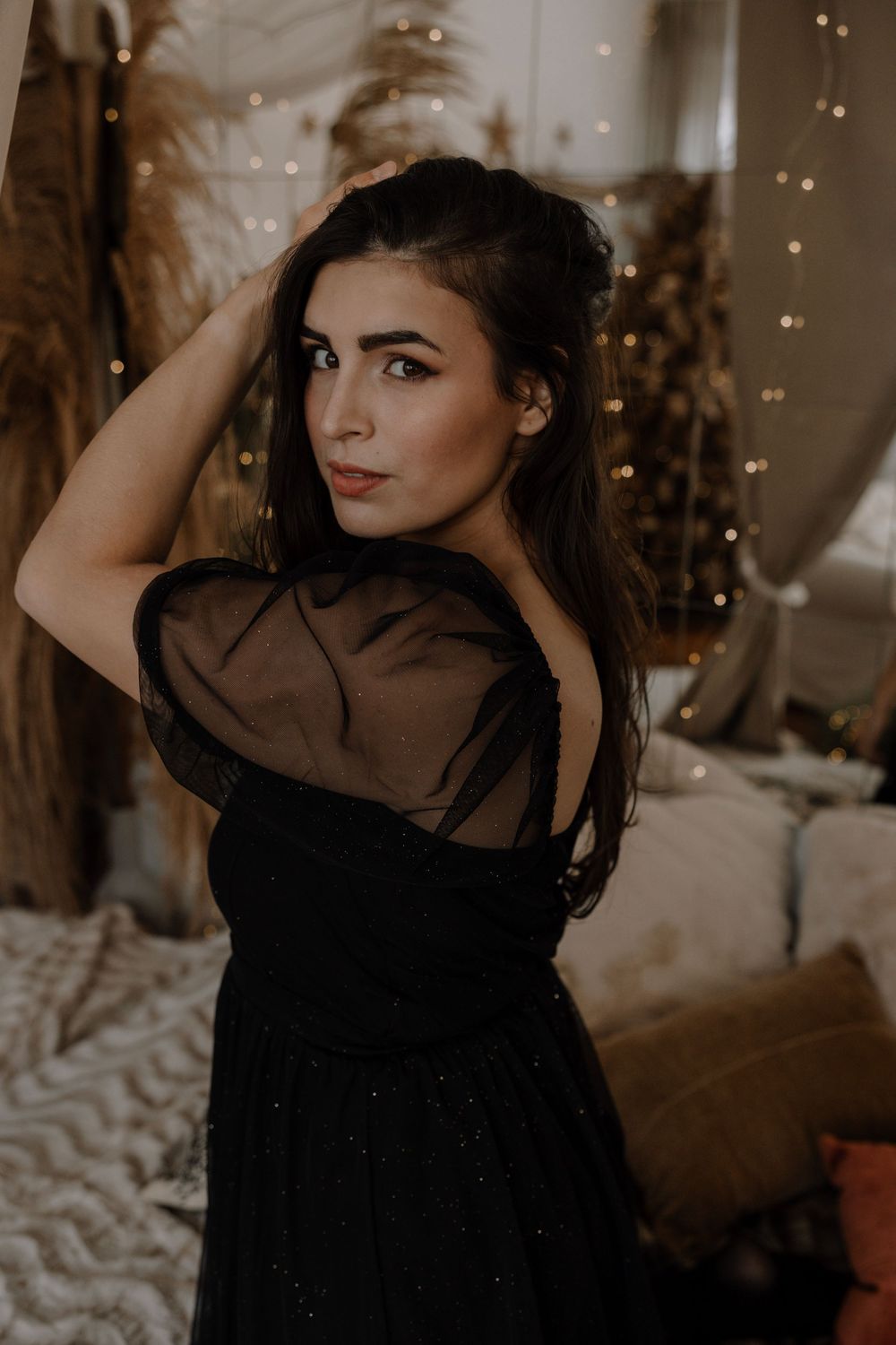Artistic portrait series showing a person in a black sheer top posing against a moody sepia-toned background.
