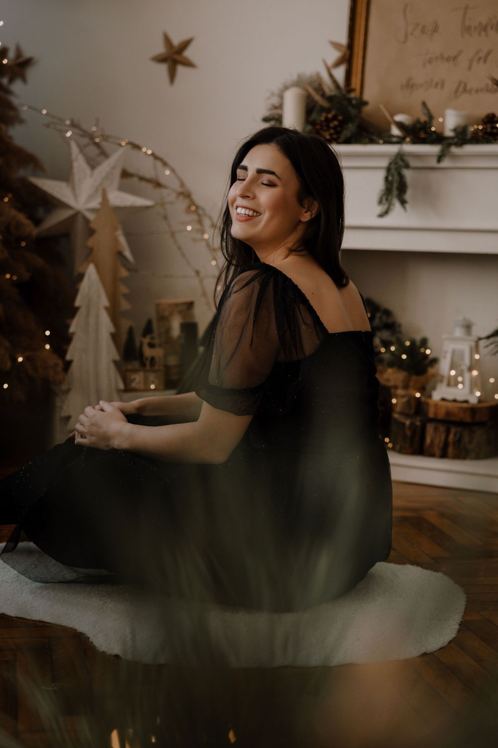 A sequence of photos shows a person in a black dress lying on a wooden floor with decorative stars in the background.