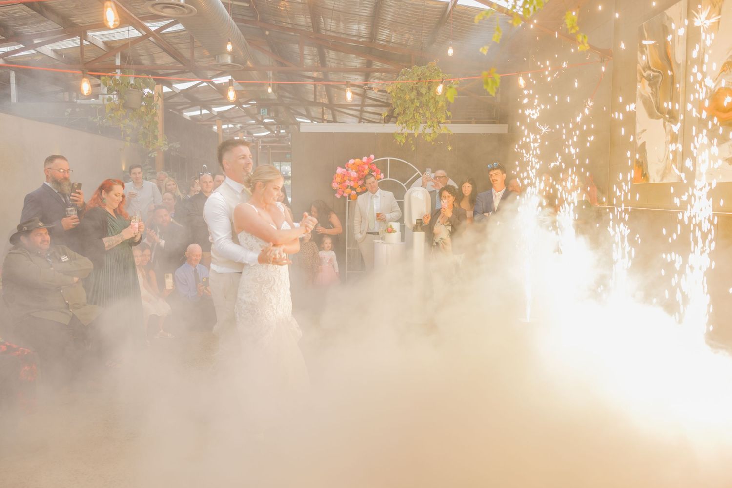 Indoor wedding celebration with sparkler effects creating a magical atmosphere.