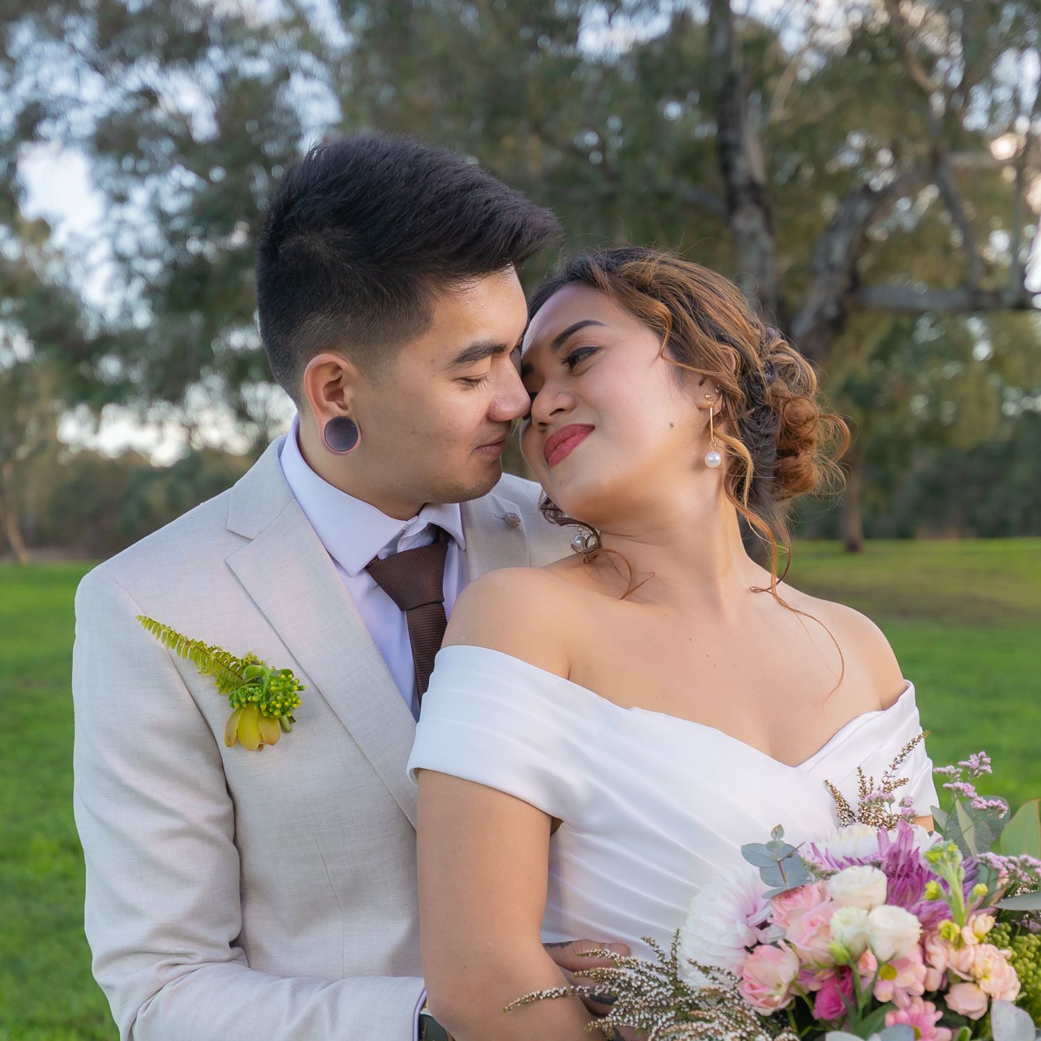 A romantic wedding portrait with soft lighting and pastel floral bouquet.