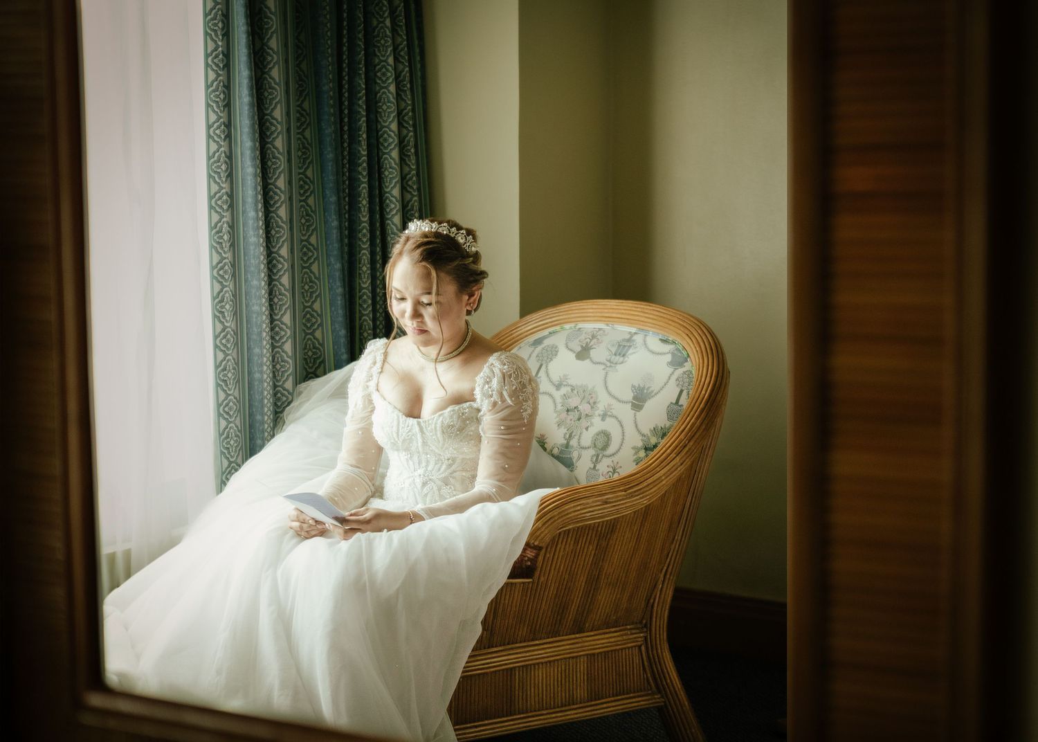 Dreamy bridal portrait with flowing veil and white wedding dress in soft sunlight.