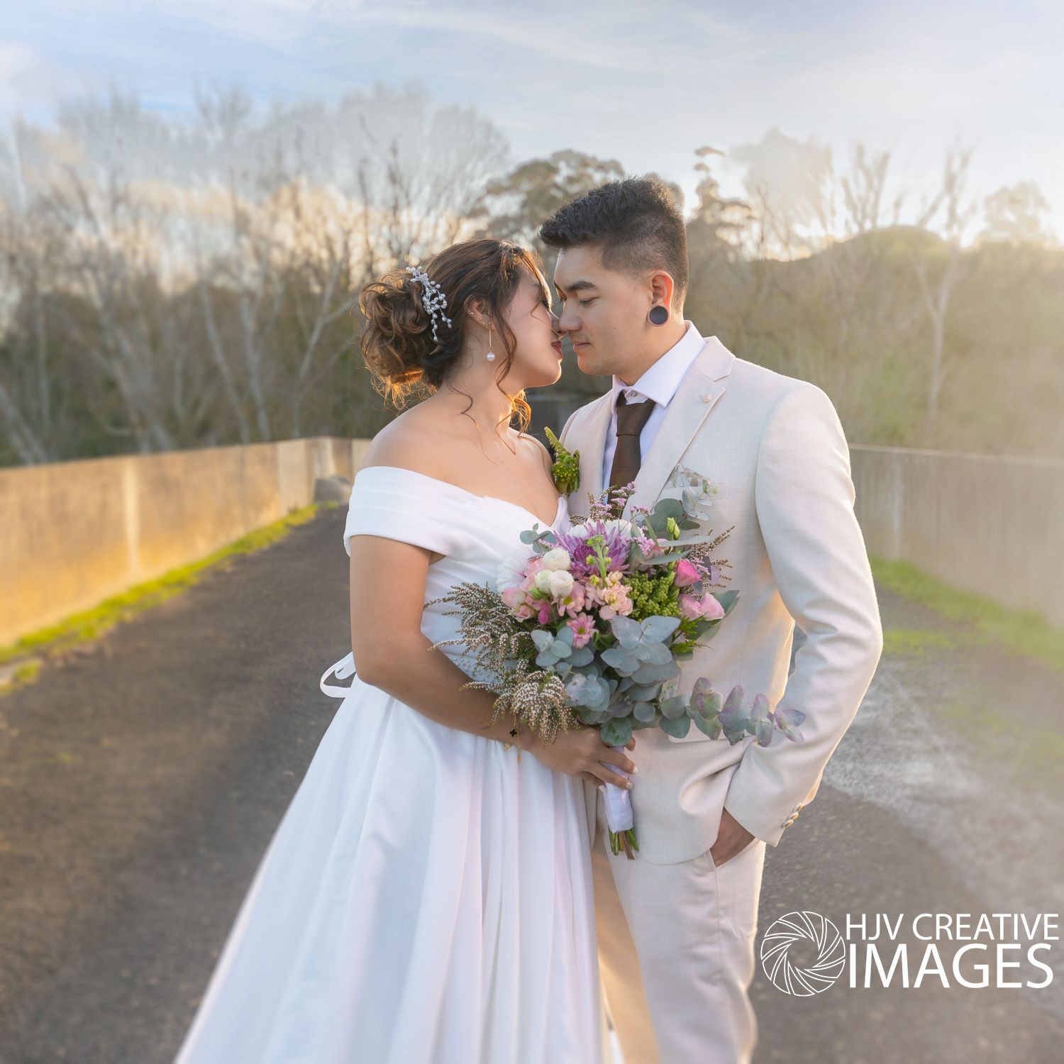 A romantic wedding portrait session with a colorful bouquet at sunset.