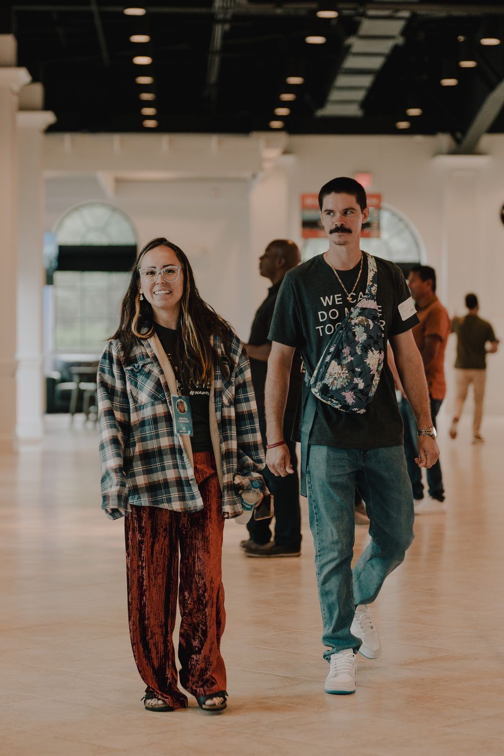 A sequence of five connected photos showing someone walking across a large empty indoor space with polished floors.