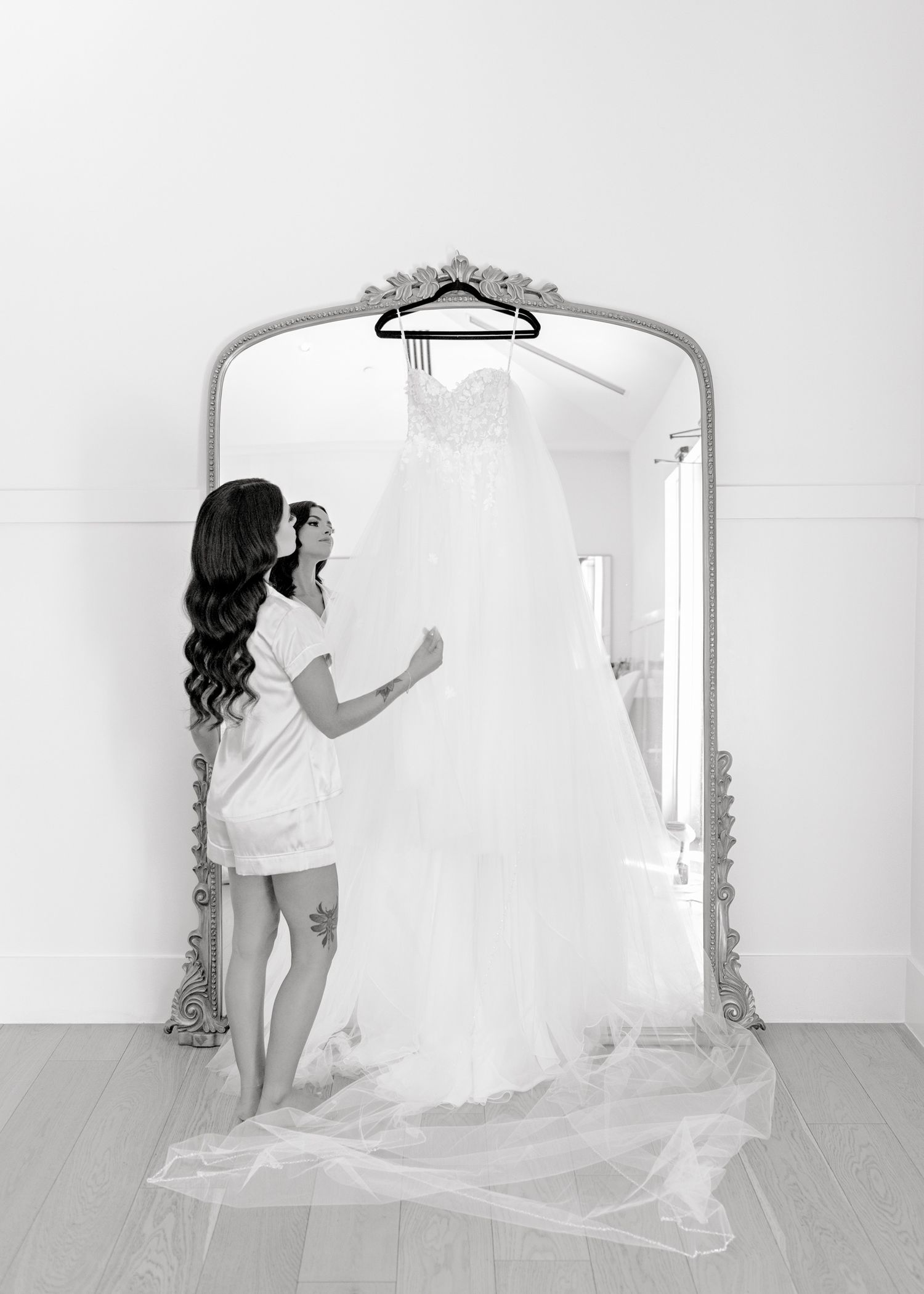 A series of photos shows someone in white adjusting a wedding dress on a hanger against a bright white wall.