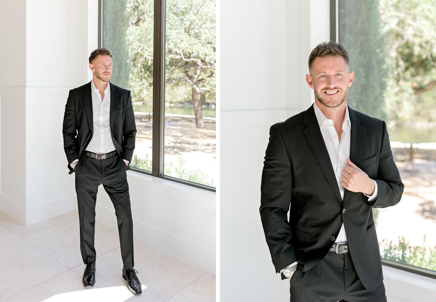 Professional portrait in black suit against bright modern architectural backdrop with natural lighting.