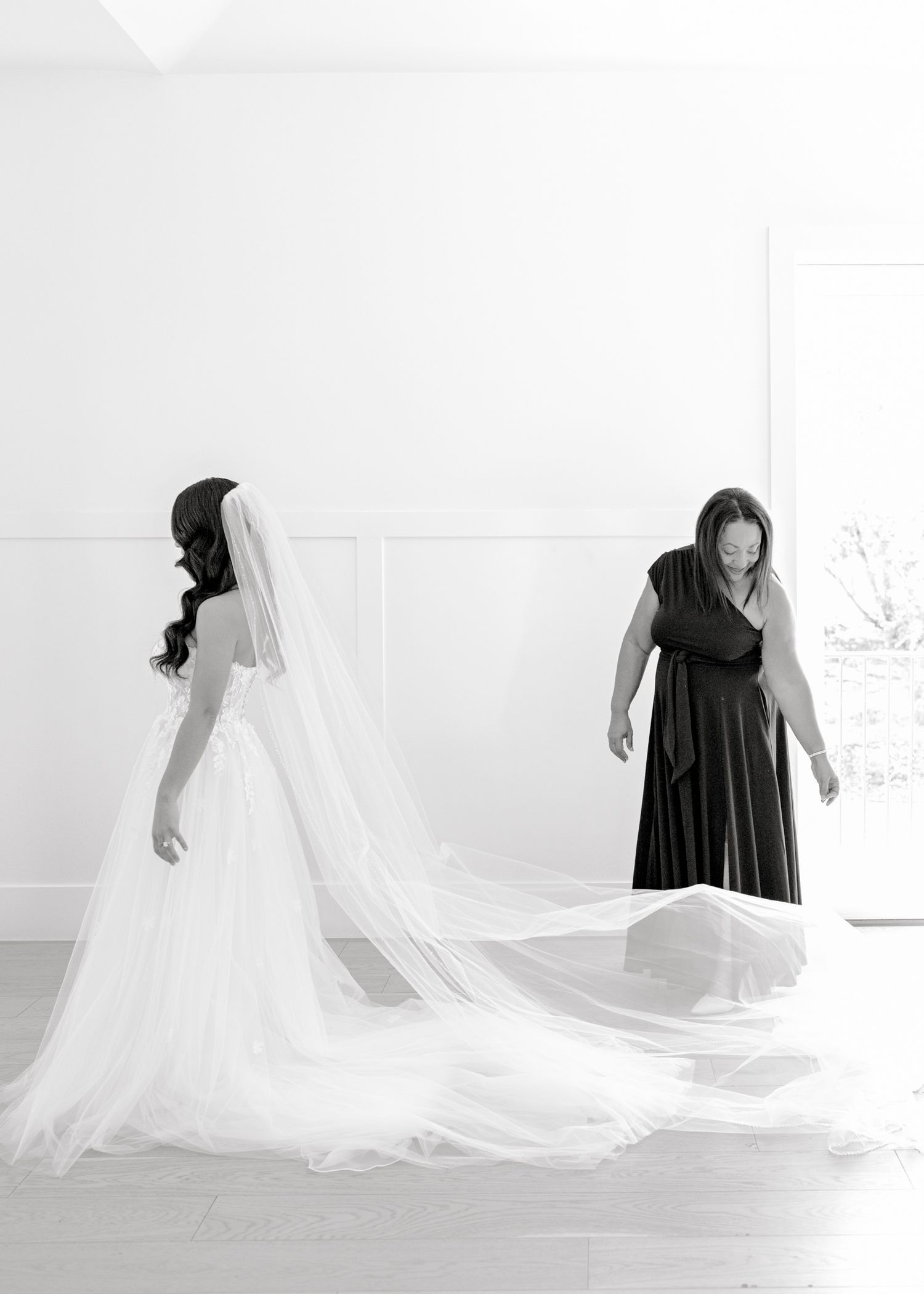 A sequence of artistic black and white photos showing a flowing wedding dress train against a white background.