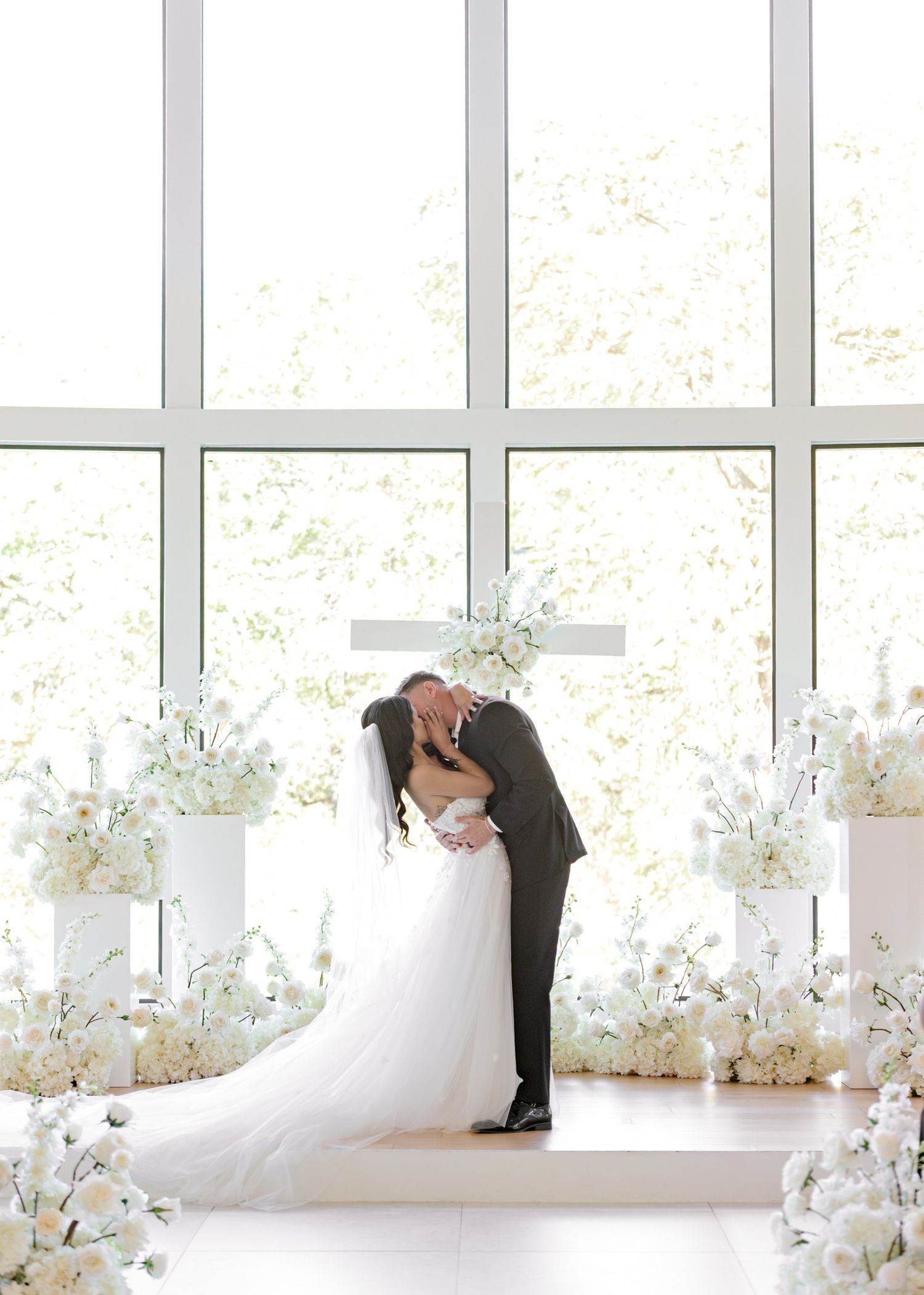 A sequence of romantic wedding photos showing a couple in an elegant white room with floral decorations.