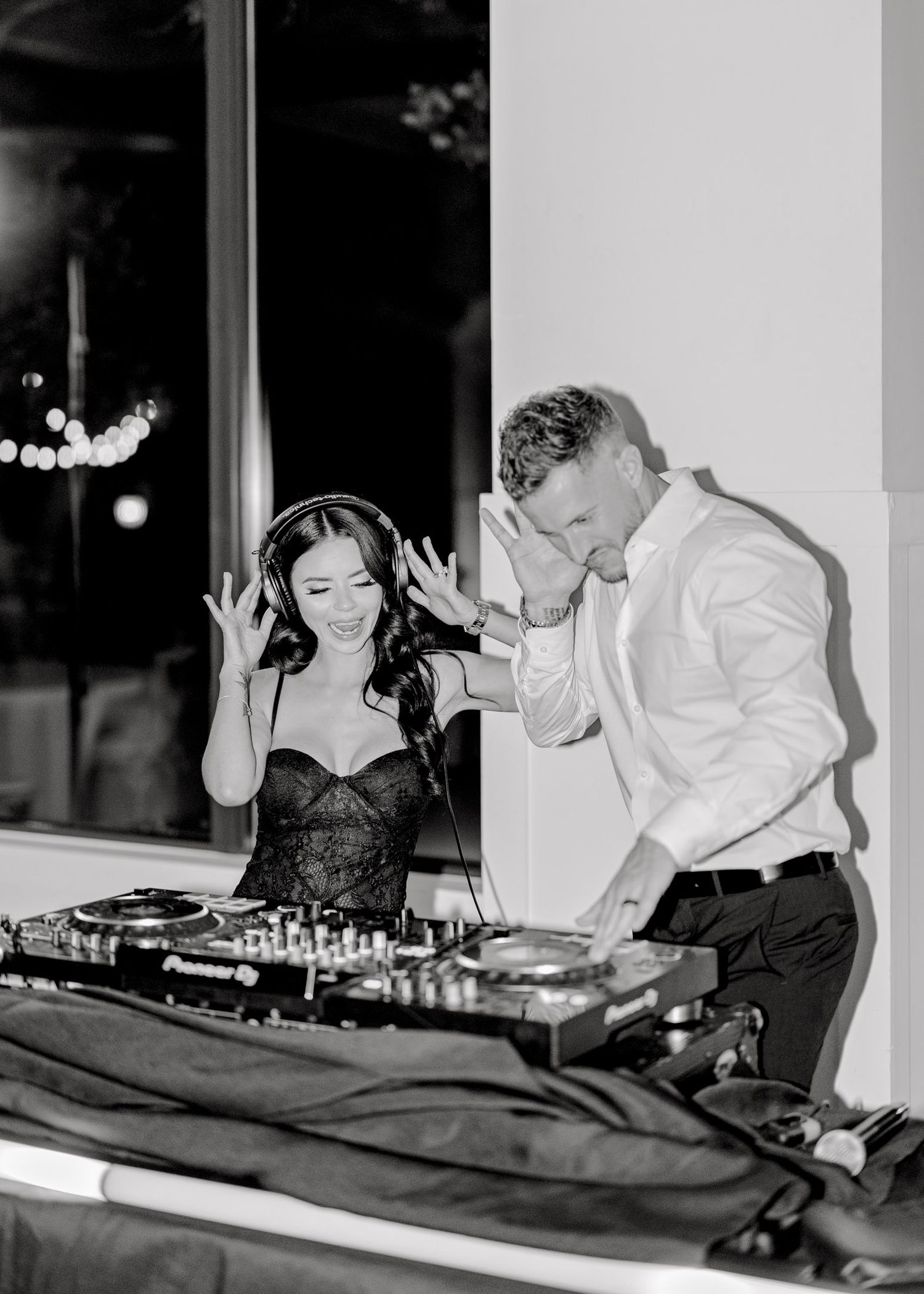 Black and white images of DJ equipment and hands working on turntables at an event.