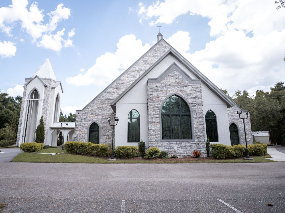 A series of small white churches with green shutters and steeples lined up along a rural road in Tampa Florida