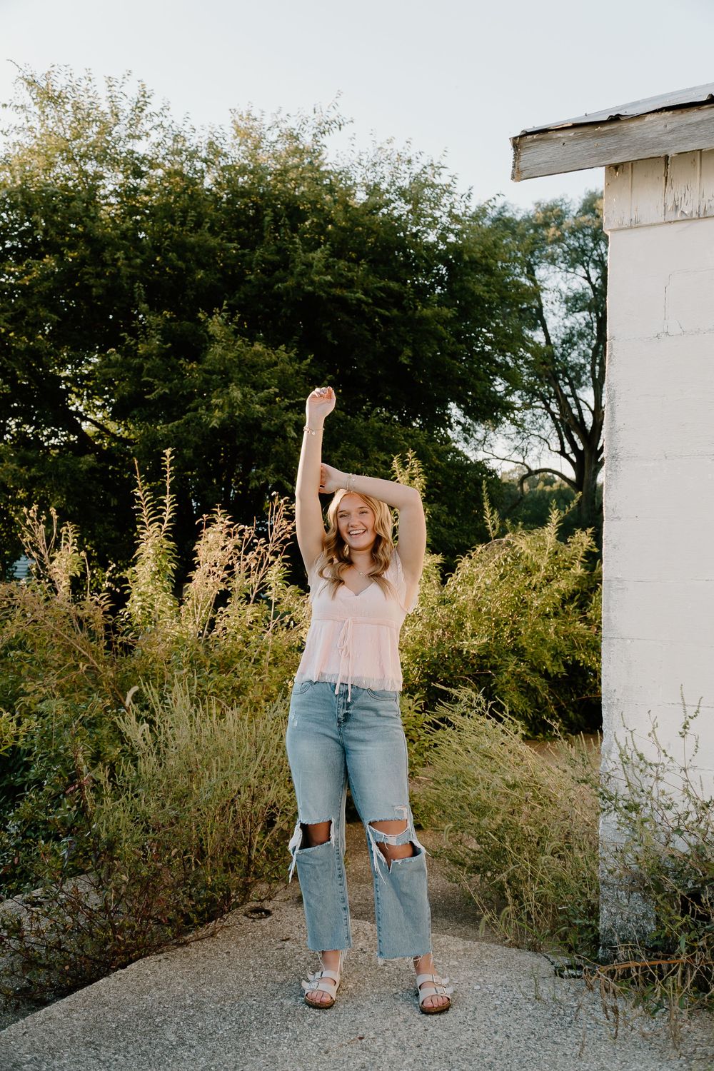 Five artistic fashion photos showing cropped views of denim jeans and shorts against a natural outdoor backdrop.