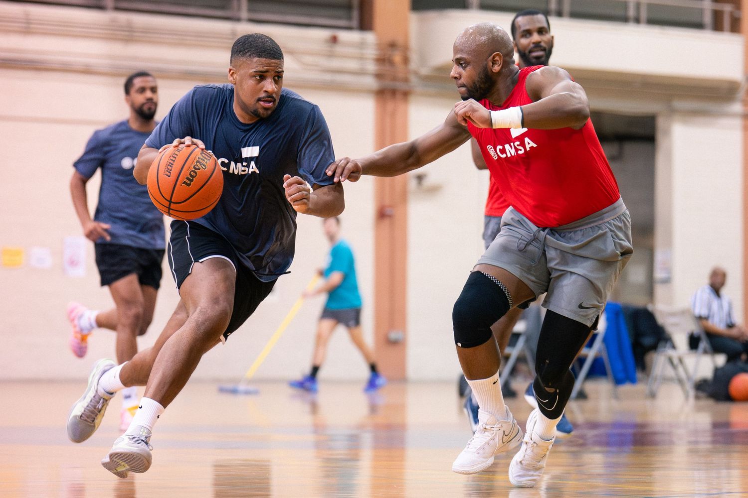 Two basketball athletes attempt to outmaneuver each other