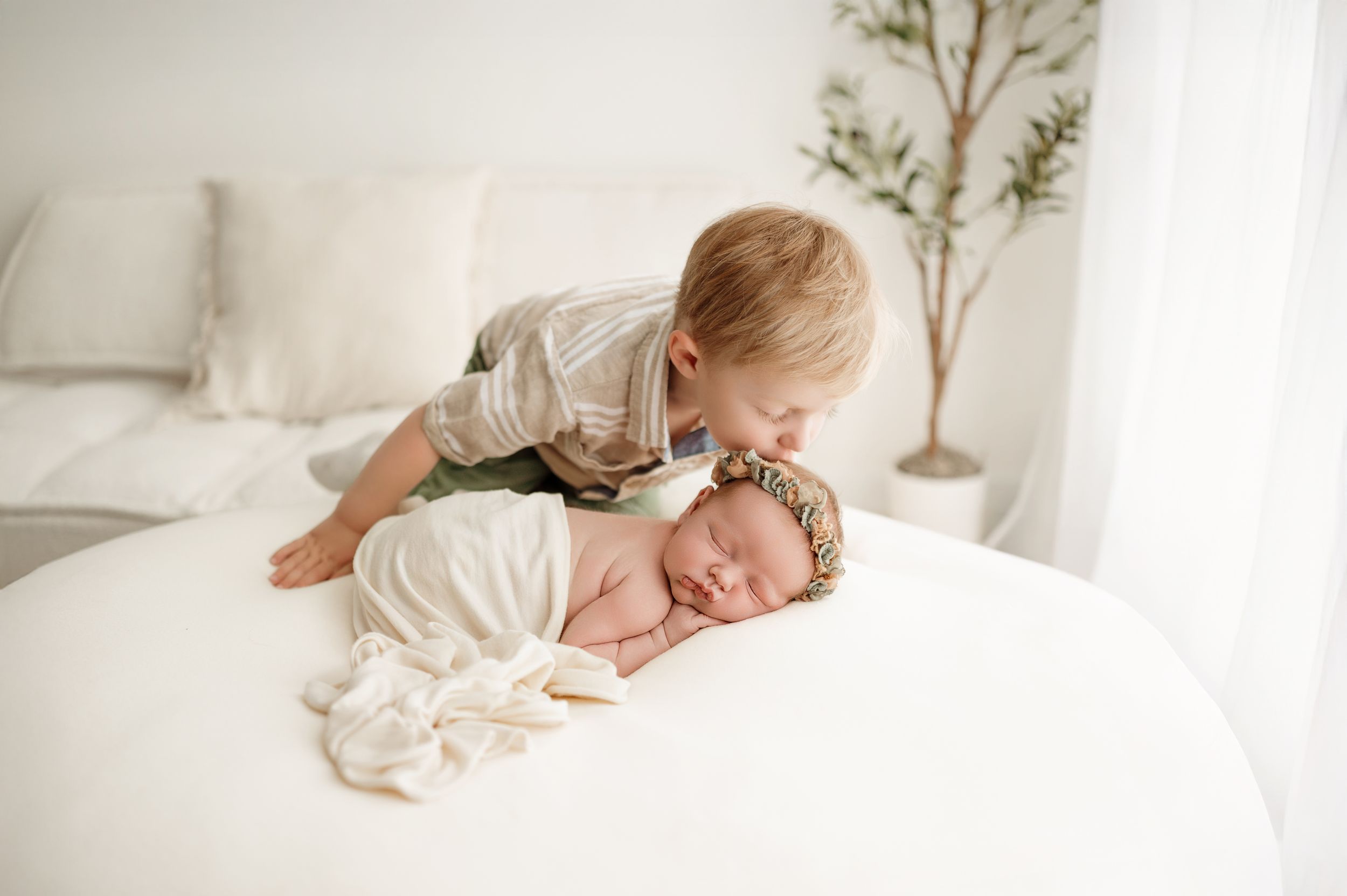 Four soothing black and white images showing a sleeping baby in cozy white bedding.