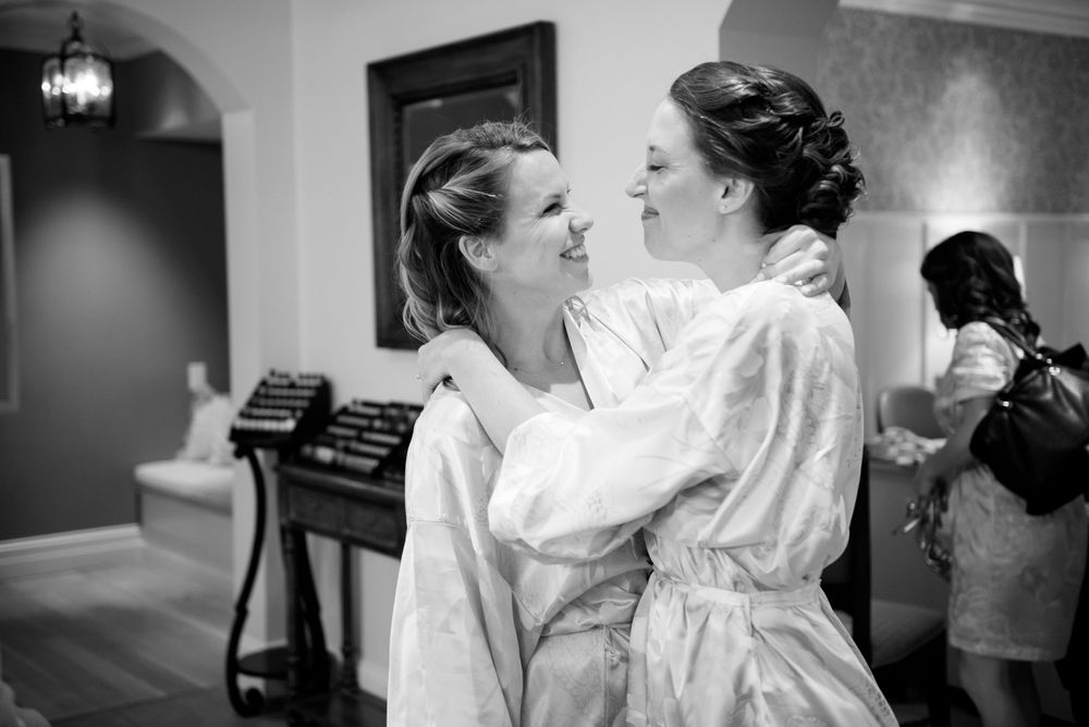 Black and white candid moments of wedding day preparations.