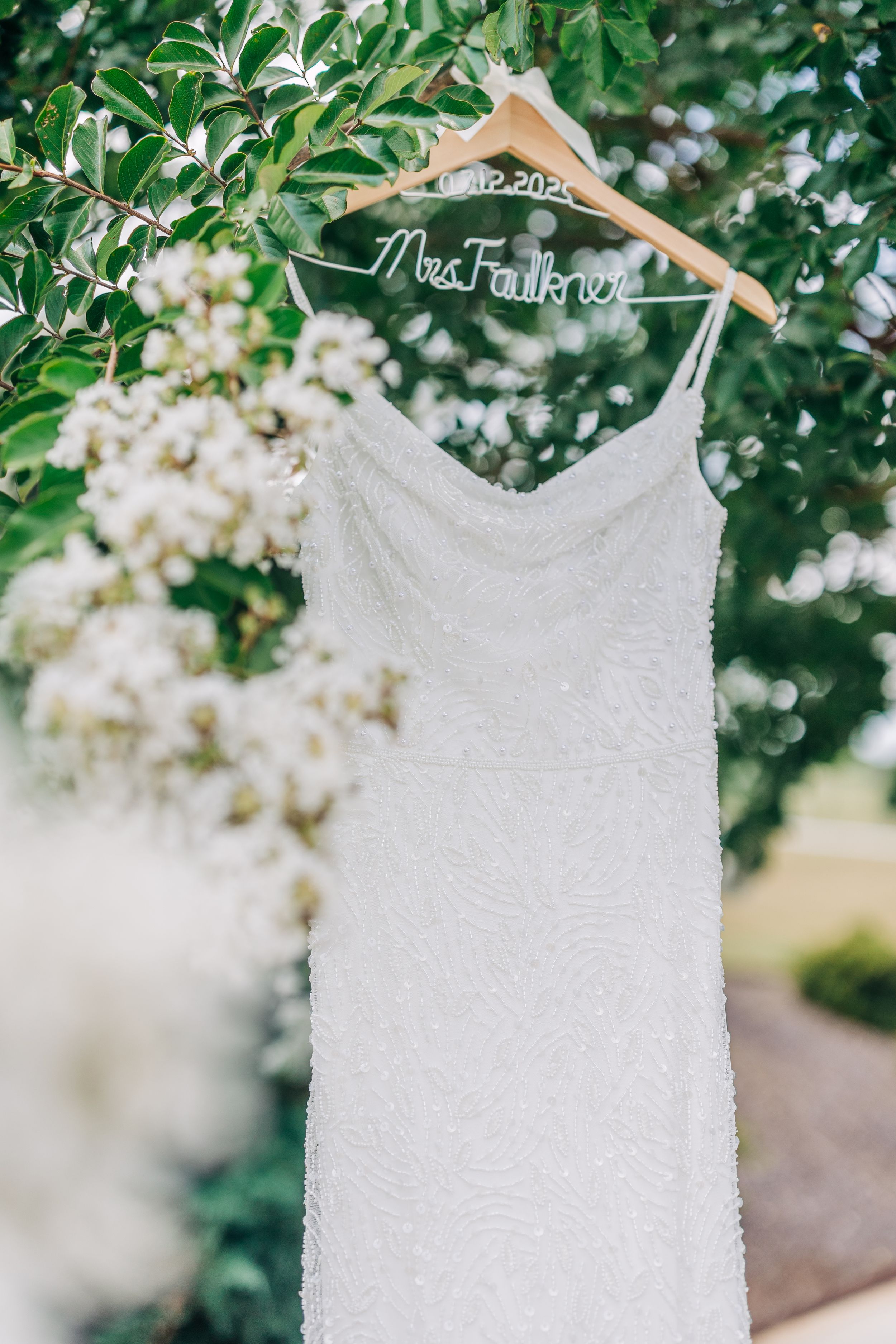 Bridal Details with wedding dress amongst white Crepe Myrtle at Barn South
