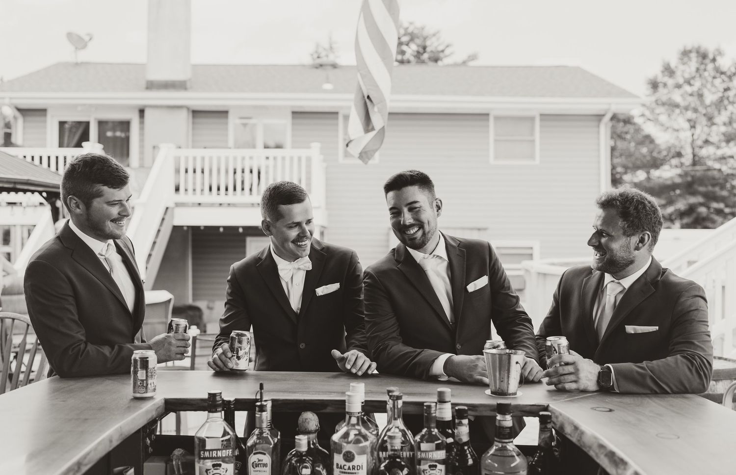 Black and white collage of wedding moments showing guests mingling at tables and the bridal party outdoors.