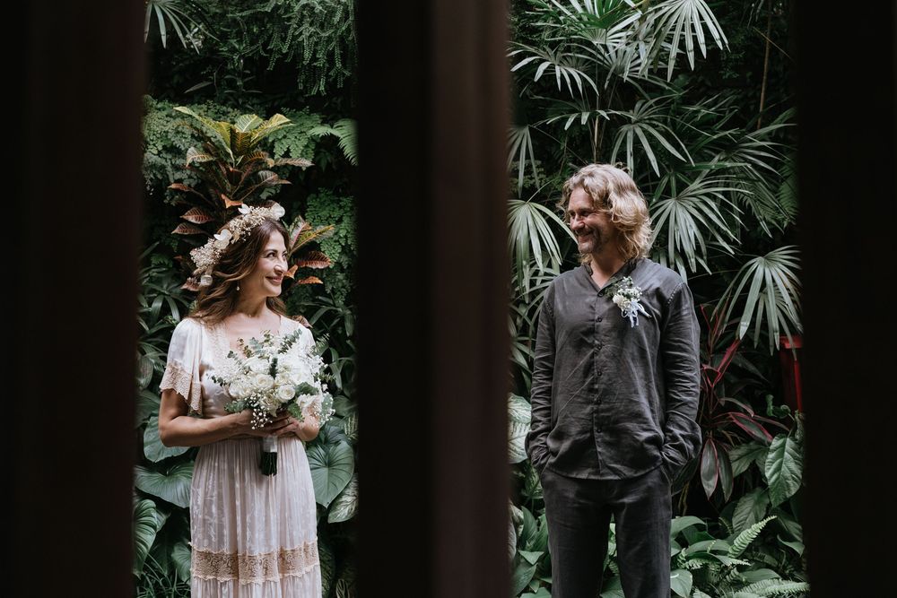 Romantic couple shares intimate moments in garden setting.